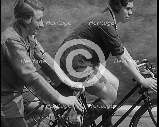 Large Group of Civilians Riding Bicycles Through Country Lanes, 1931. Creator: British Pathe Ltd.