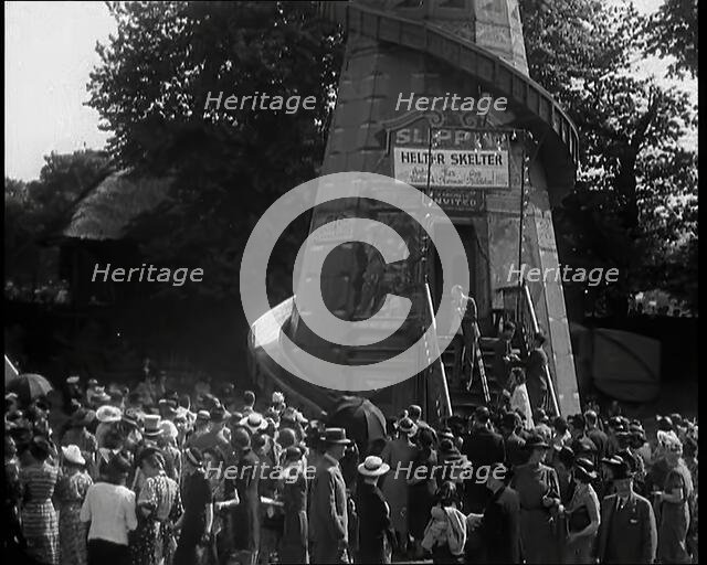 A Helter Skelter Fairground Ride in a Park With a Man at  the Entrance With a Megaphone..., 1939. Creator: British Pathe Ltd.