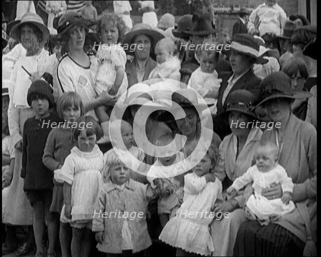 British Mothers Sitting With Their Babies on Their Laps at a Baby Show, 1920. Creator: British Pathe Ltd.