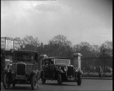 London Bus, Cars and Taxis Turning a Corner on a London Street, 1924. Creator: British Pathe Ltd.