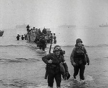 American Troops Walking Onto a North African Beach as Part of 'Operation Torch', 1942. Creator: British Pathe Ltd.