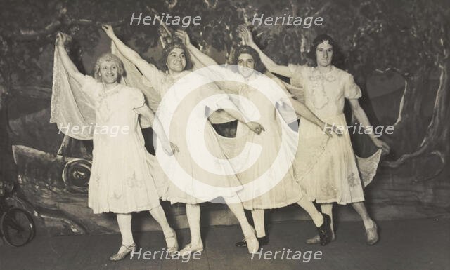 Amateur actors in drag, wearing white dresses and dancing on stage, [between 1910 and 1919?]. Creator: Unknown.
