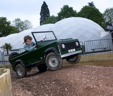 Child driving a toy Land Rover. Artist: Unknown.