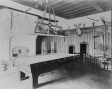 Billiard room, with a deer head and an elk head, in home of Edmund..., Greenwich, Connecticut, 1908. Creator: Frances Benjamin Johnston.