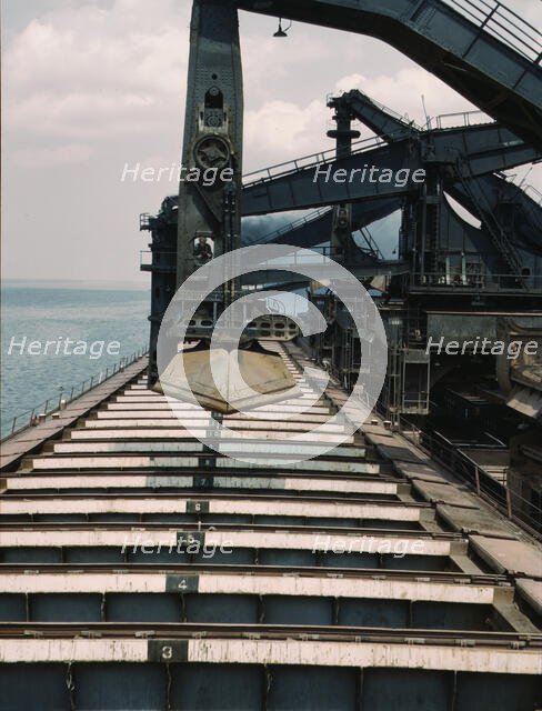 Pennsylvania R.R. iron ore docks, unloading ore from a lake freighter...ore unloaders, 1943. Creator: Jack Delano.