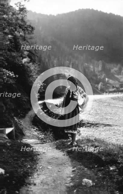 Young woman on a mountain footpath, Bistrita Valley, Moldavia, north-east Romania, c1920-c1945. Artist: Adolph Chevalier