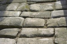 Remains of a Roman road next to the Valmardon Gate, paved with granite slabs, Toledo, Spain, 2022. Creator: LTL.