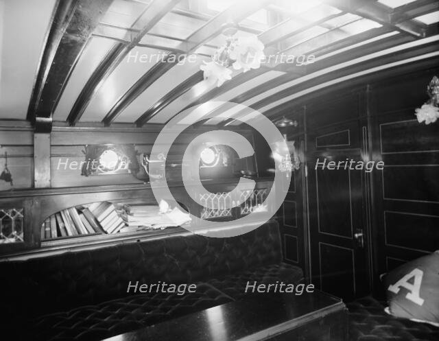 Yacht Althea, cabin, showing books, between 1907 and 1915. Creator: Unknown.