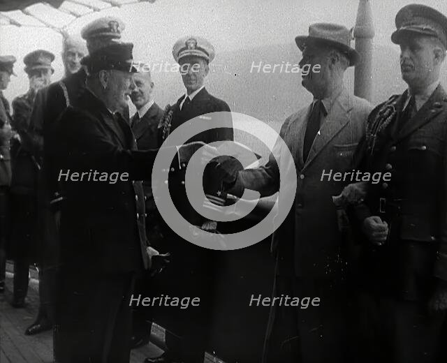 Winston Churchill Handing Franklin D. Roosevelt a Piece of Paper, 1941. Creator: British Pathe Ltd.