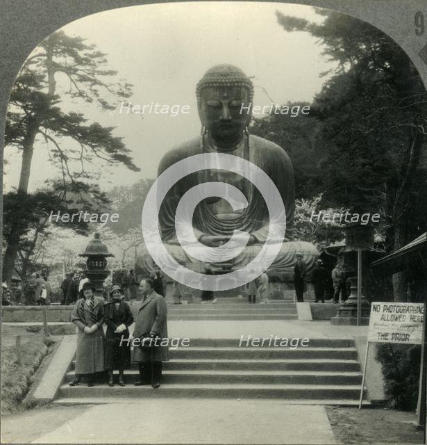 'The Colossal Daibutsu in Cherry-Blossom Time - the Great Bronze Buddha of Kamakura, Japan', c1930s. Creator: Unknown.
