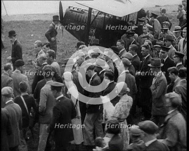 Jim Mollison Walking to His Plane With a Large Crowd, 1930s. Creator: British Pathe Ltd.