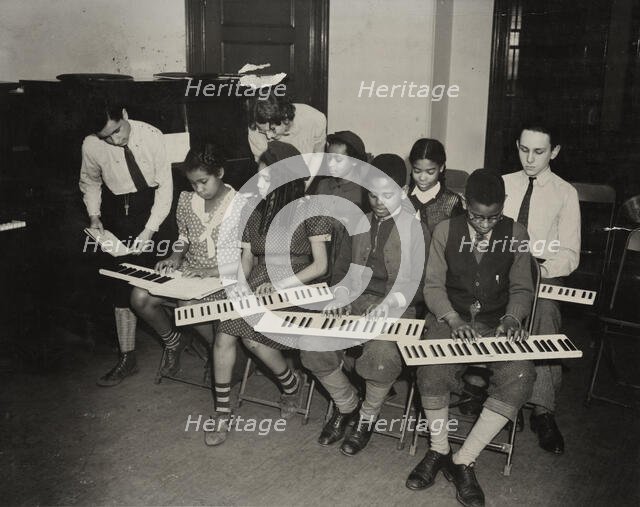 Music classes, keyboards, 1938. Creator: Aubrey Pollard.