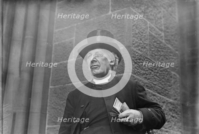 Bishop of Salisbury holding glasses and train schedule, 1910. Creator: Bain News Service.