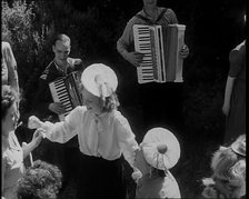 A Group of British Girls Dancing As Two British Men Play Accordion Music, 1938. Creator: British Pathe Ltd.