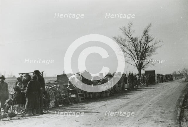 Evicted African American sharecroppers standing with their belongings along Highway 60..., Jan 1939. Creators: Farm Security Administration, Arthur Rothstein.
