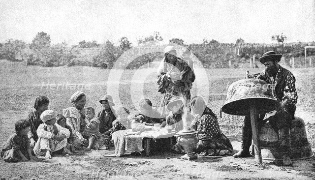 Gypsies mending a family cauldron, Hungary, 1922.Artist: AW Cutler