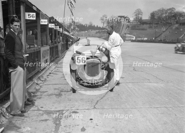 J Reeves and HHB Beacon's Austin Ulster in the pits, JCC Double Twelve race, Brooklands, 1931. Artist: Bill Brunell.