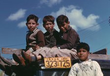 Boys sitting on truck parked at the FSA ... labor camp, Robstown, Tex., 1942. Creator: Arthur Rothstein.