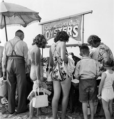 Holidaymakers around a seafood stall, Blackpool Beach, c1946-1955. Artist: John Gay