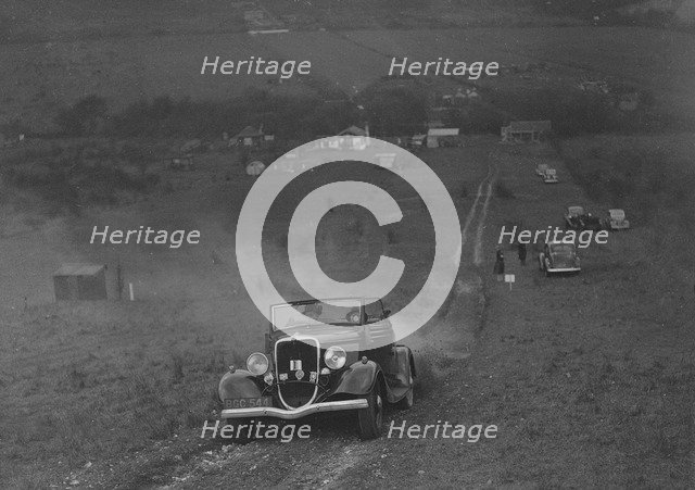 Ford V8 competing in the London Motor Club Coventry Cup Trial, Knatts Hill, Kent, 1938. Artist: Bill Brunell.