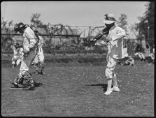 Bampton Morris troupe performing in a 'Pipe Dance', with a fiddle player,  Oxfordshire, 1920-30.  Creator: George R Long.