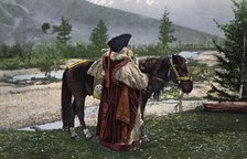 Altai Woman in National Costume (Hat: Kuaraan Boruk, Sheepskin Coat: Ton, Sleeveless..., 1911-1913. Creator: Sergei Ivanovich Borisov.