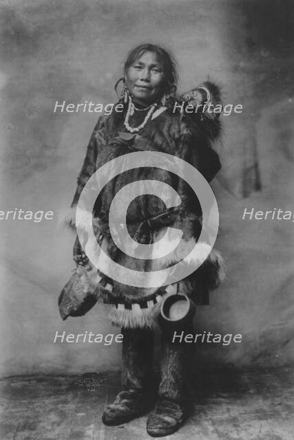 Eskimo mother carrying a child on her back, 1916(?). Creator: Unknown.