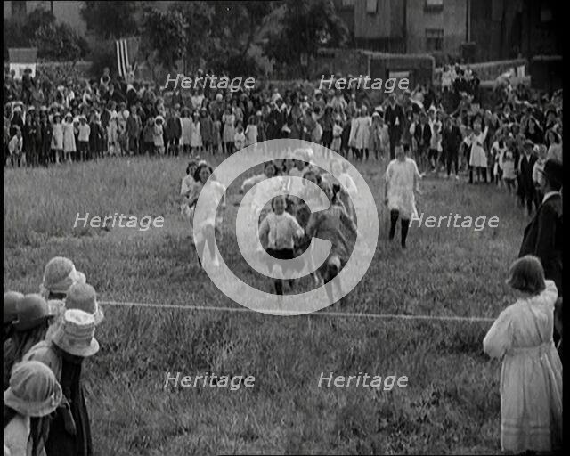 Young Girls Finishing a Running Race in a Field, 1920. Creator: British Pathe Ltd.