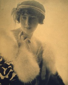 Half-length portrait of a woman wearing a fur trimmed coat, facing front, between 1900 and 1920. Creator: Unknown.