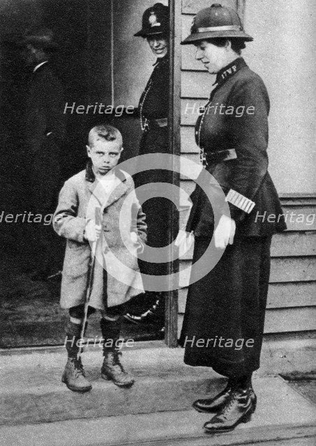 An East End child and a policewoman, London, 1926-1927. Artist: Unknown