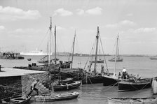 Men working on Bawley boats moored at a quay at Gravesend, c1945-c1965. Artist: SW Rawlings