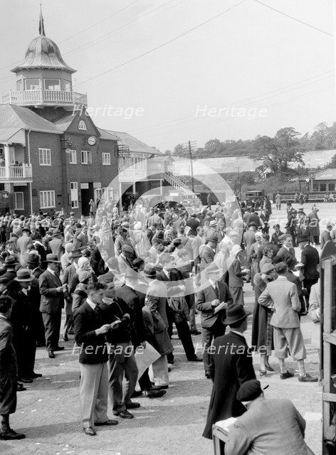 People attending a motor racing event at Brooklands. Artist: Bill Brunell.