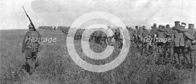 'A travers le champ de bataille; colonne de prisonniers allemands diriges sur l'arriere..., 1918. Creator: Unknown.