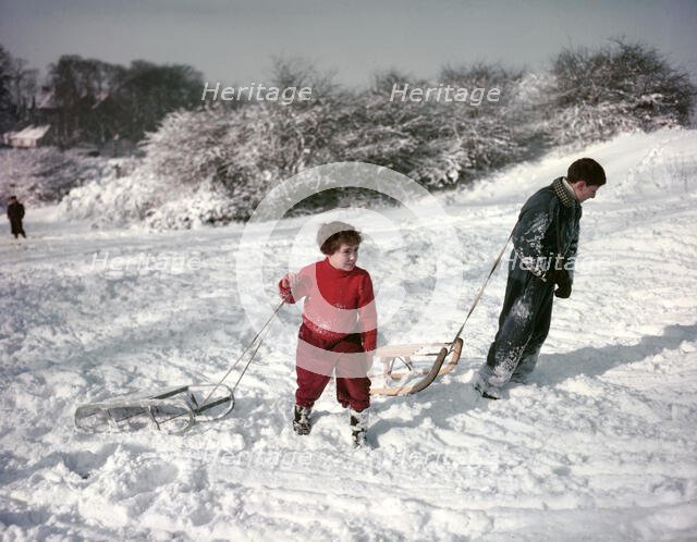Sledging on Hampstead Heath, London, c1955.  Creator: Arthur Charles Kirby Ware.
