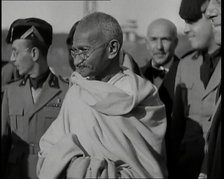 Mahatma Gandhi Standing with Others, 1930s. Creator: British Pathe Ltd.