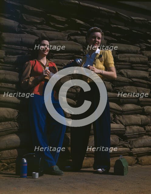 Lunchtime brings a few minutes of rest...Douglas Aircraft Company's plant, Long Beach, Calif. , 1942 Creator: Alfred T Palmer.