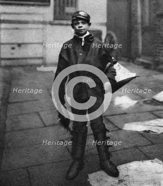 'Scavenger boy', who cleans up horse droppings in the road, London, 1926-1927. Artist: Unknown