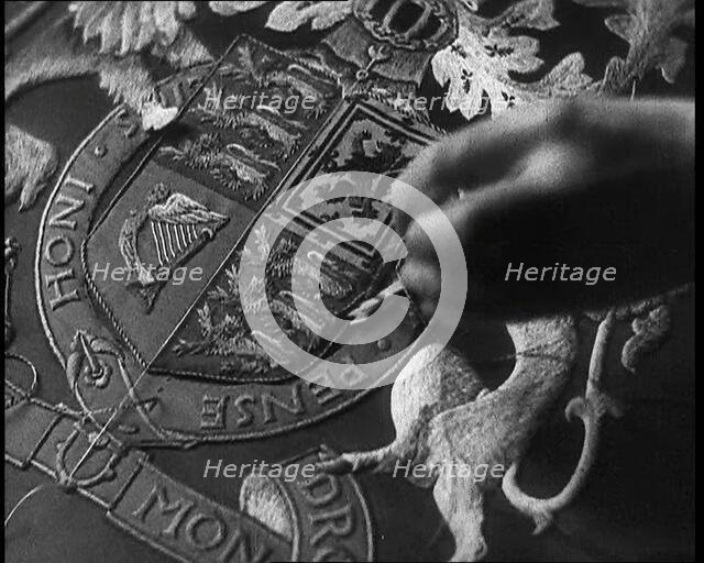 Hand of Seamstress Sewing a Royal Emblem, 1937. Creator: British Pathe Ltd.