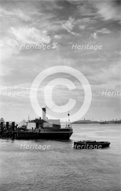 Cars embark on a ferry at Gravesend, Kent, for an evening crossing of the Thames, c1945-c1965. Artist: SW Rawlings