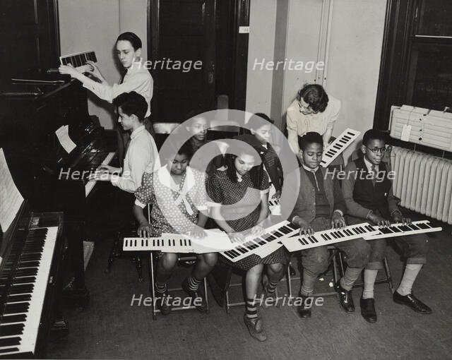 Music classes, keyboards and piano, 1938. Creator: Aubrey Pollard.