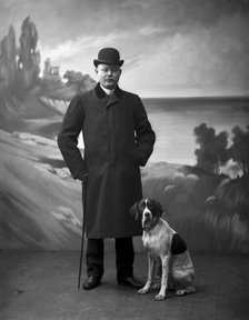Elegant man wearing a black overcoat posing with his dog, Landskrona, Sweden, 1910. Artist: Unknown