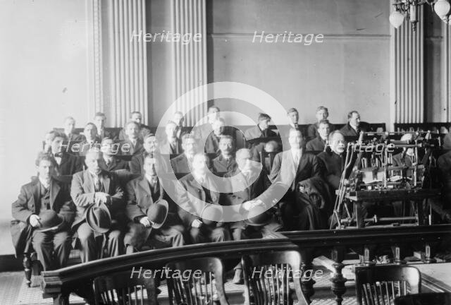 Candidates for naturalization seated in room, hats in laps, 1916. Creator: Bain News Service.
