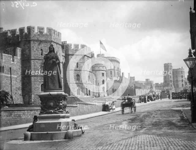 Windsor Castle from Pedscoe Street with a statue of Queen Victoria, Windsor, Berkshire, c1860-c1922. Artist: Henry Taunt