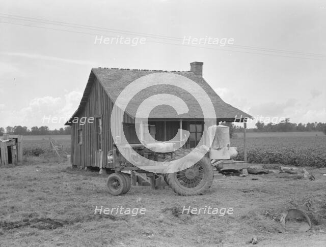 Tractors with pneumatic tires are replacing mules on the Delta plantations, Arkansas, 1939. Creator: Dorothea Lange.
