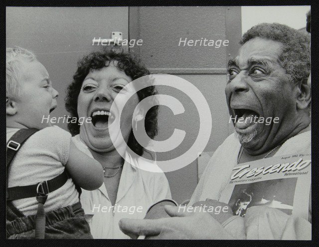 Dizzy Gillespie meeting baby Gary Colfer at Knebworth, Hertfordshire, July 1982. Artist: Denis Williams