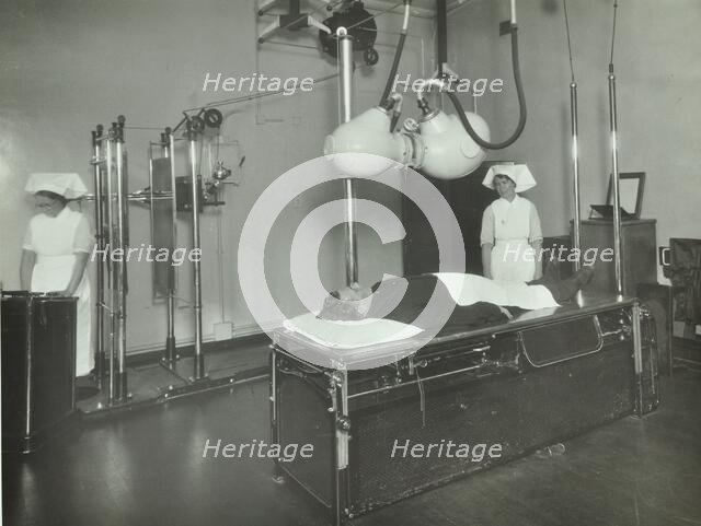 A patient undergoes a medical procedure, c1950s. Creator: Unknown.