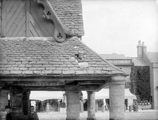 Boy poking his head through the roof of the 17th-century Buttercross, Witney, Oxon, c1860-c1922. Artist: Henry Taunt