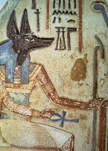 Detail of god Anubis in a familiar stela from a chapel of worship.