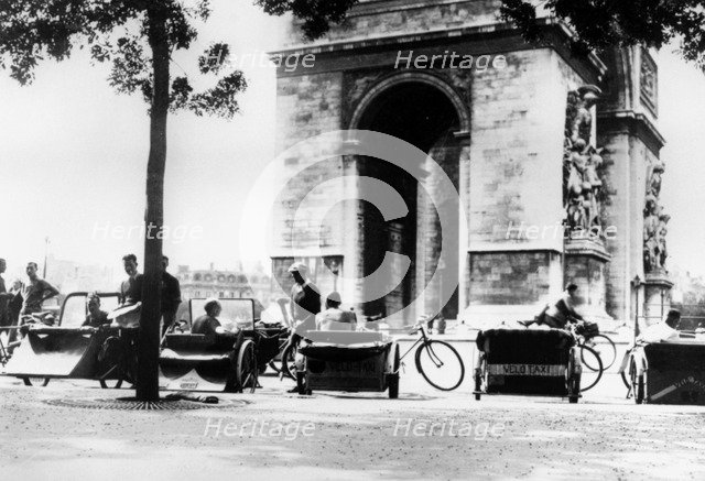 Bicycle taxis in the Place d'Etoile by the Arc de Triomphe, German-occupied Paris, August 1943. Artist: Unknown