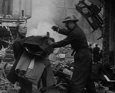 Men Clearing Out Possessions from a Bombed Out Building, 1940. Creator: British Pathe Ltd.